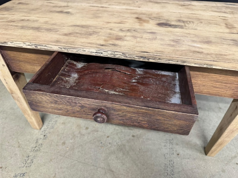 A low French oak coffee table with a rectangular light wood plank top, a single frieze drawer, and tapered square legs. View IV