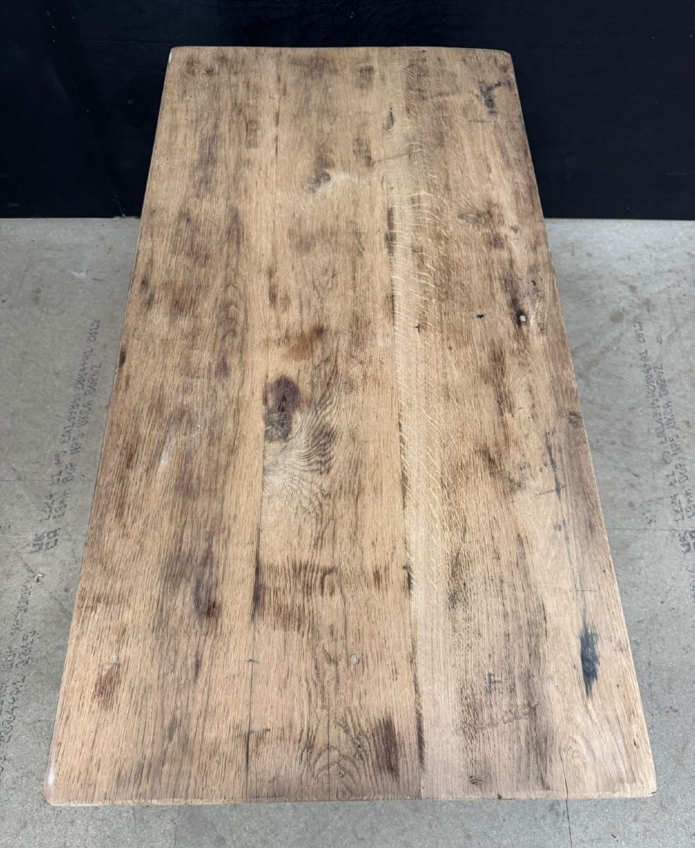 A low French oak coffee table with a rectangular light wood plank top, a single frieze drawer, and tapered square legs. View VI
