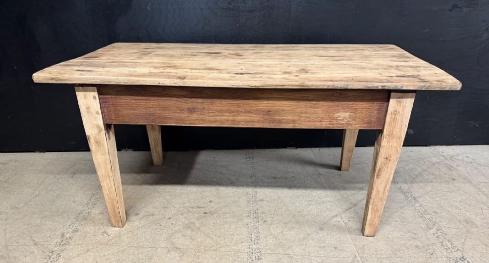 A low French oak coffee table with a rectangular light wood plank top, a single frieze drawer, and tapered square legs. View VIII