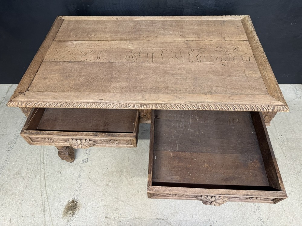 A French bleached oak writing desk featuring hand-carved floral drawer fronts, egg-and-dart moulding, turned barley twist legs, and an H-stretcher base. View IV
