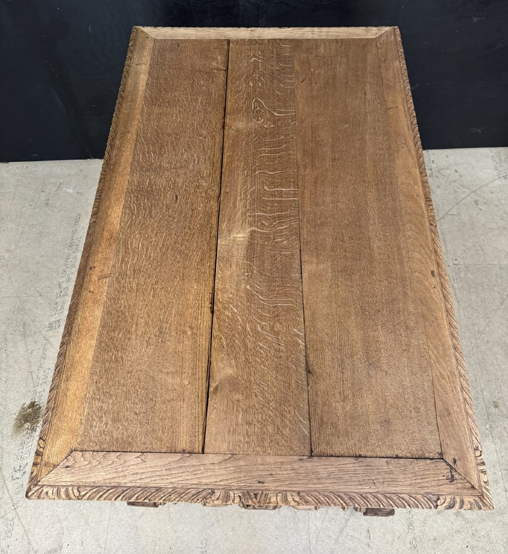 A French bleached oak writing desk featuring hand-carved floral drawer fronts, egg-and-dart moulding, turned barley twist legs, and an H-stretcher base. View IX