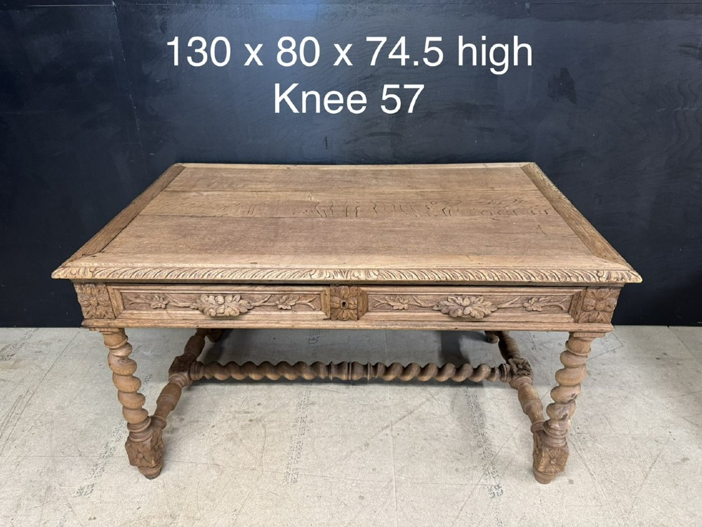 A French bleached oak writing desk featuring hand-carved floral drawer fronts, egg-and-dart moulding, turned barley twist legs, and an H-stretcher base. View XIV