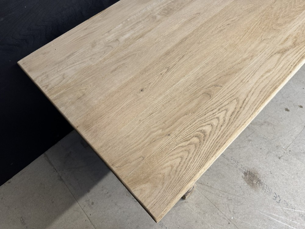 A large light oak farmhouse dining table featuring a solid plank top, turned legs, and an H-shaped stretcher base. View VIII