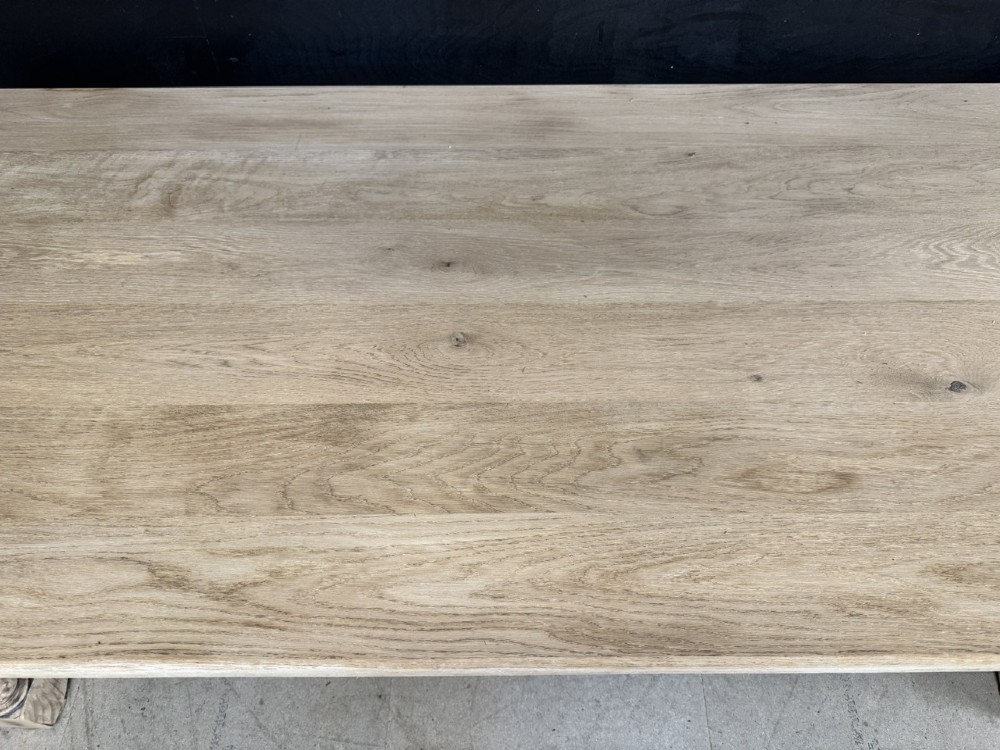 A large light oak farmhouse dining table featuring a solid plank top, turned legs, and an H-shaped stretcher base. View XII