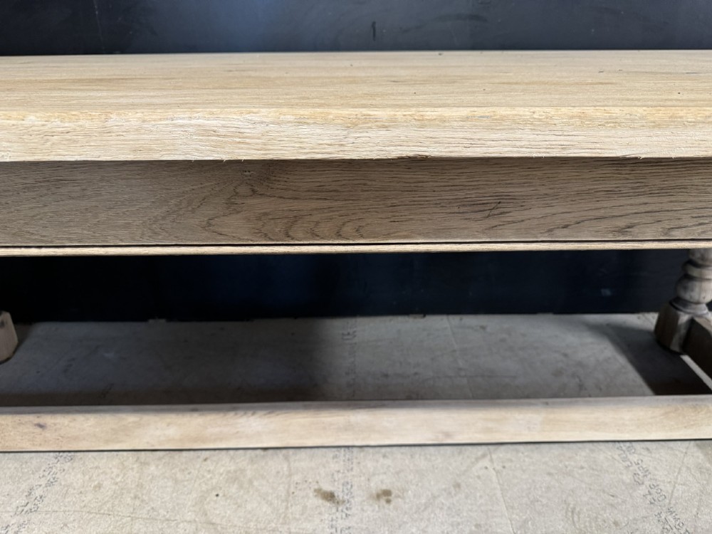 A large light oak farmhouse dining table featuring a solid plank top, turned legs, and an H-shaped stretcher base. View XIV