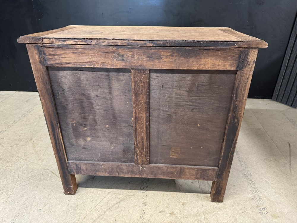 A French provincial bleached oak commode featuring three drawers with carved decorative mouldings and cast metal handles. View IX