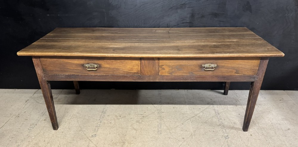 A rectangular antique French chestnut console prep table featuring two drawers with brass drop handles and square tapered legs.