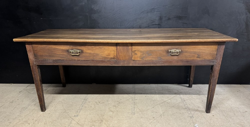 A rectangular antique French chestnut console prep table featuring two drawers with brass drop handles and square tapered legs. View II