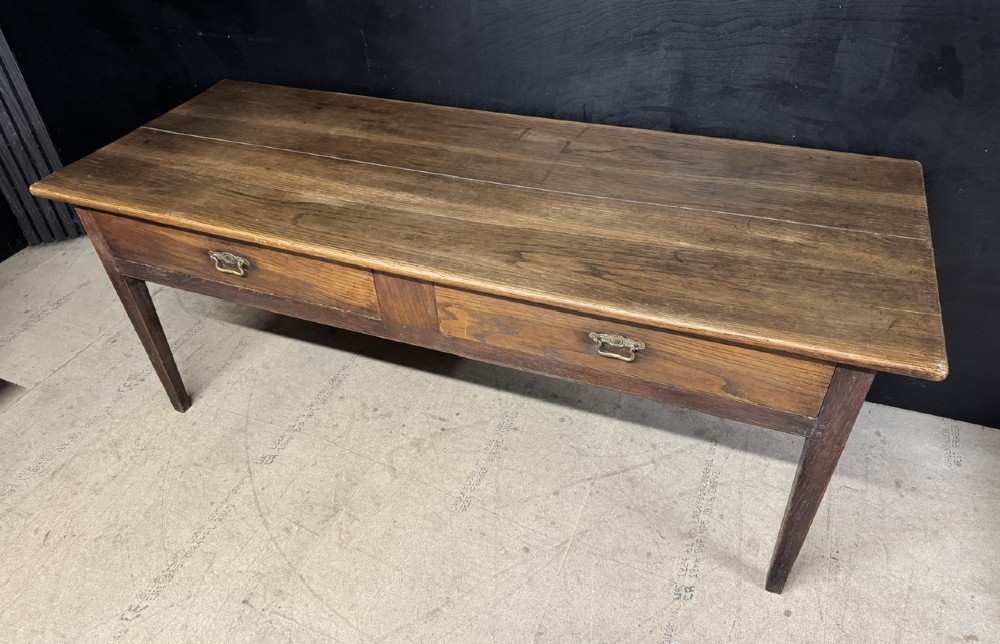 A rectangular antique French chestnut console prep table featuring two drawers with brass drop handles and square tapered legs. View III