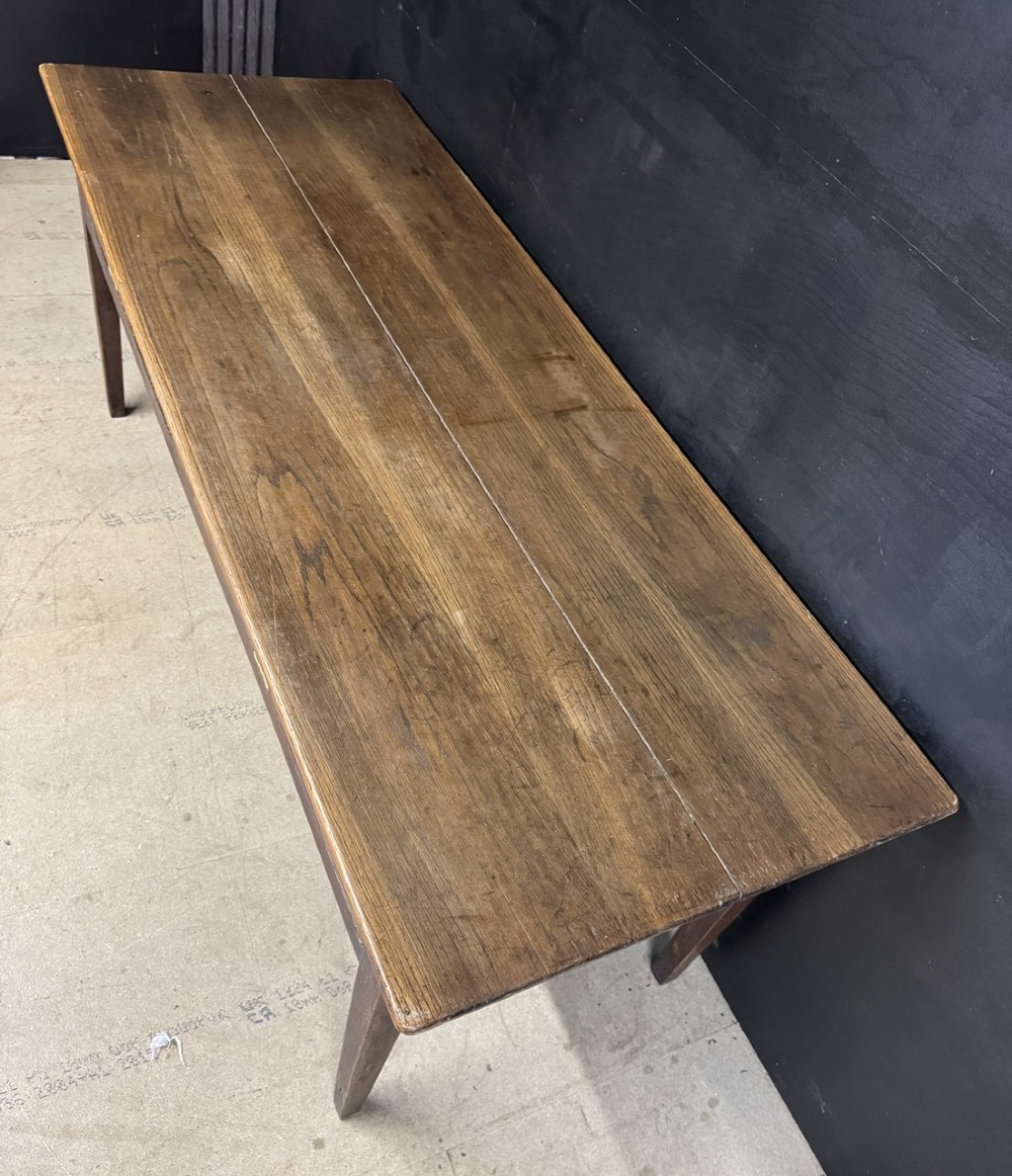 A rectangular antique French chestnut console prep table featuring two drawers with brass drop handles and square tapered legs. View V