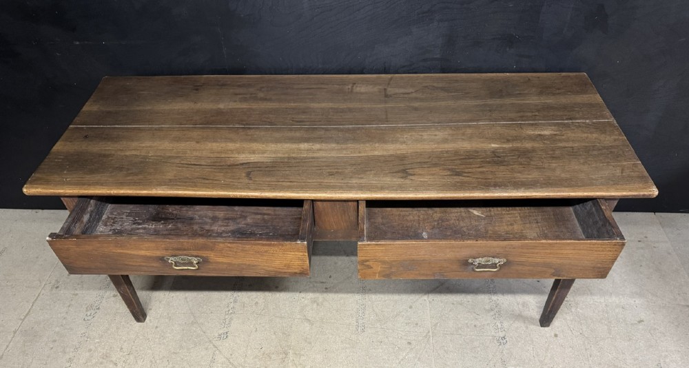 A rectangular antique French chestnut console prep table featuring two drawers with brass drop handles and square tapered legs. View VI