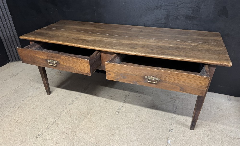 A rectangular antique French chestnut console prep table featuring two drawers with brass drop handles and square tapered legs. View VII