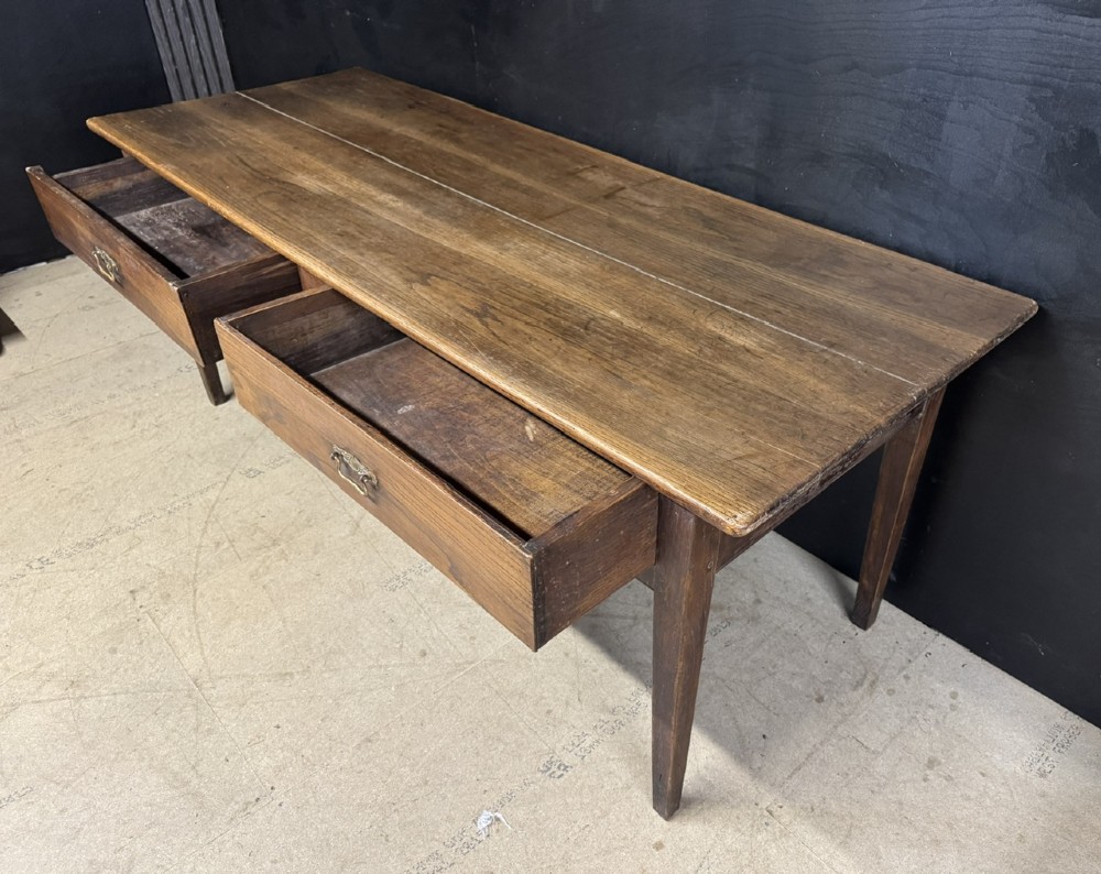 A rectangular antique French chestnut console prep table featuring two drawers with brass drop handles and square tapered legs. View IX