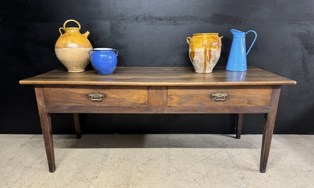 A rectangular antique French chestnut console prep table featuring two drawers with brass drop handles and square tapered legs. View XII