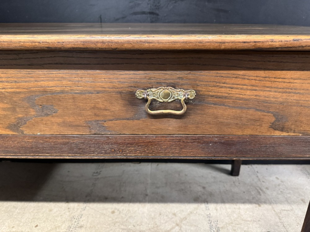 A rectangular antique French chestnut console prep table featuring two drawers with brass drop handles and square tapered legs. View XIII