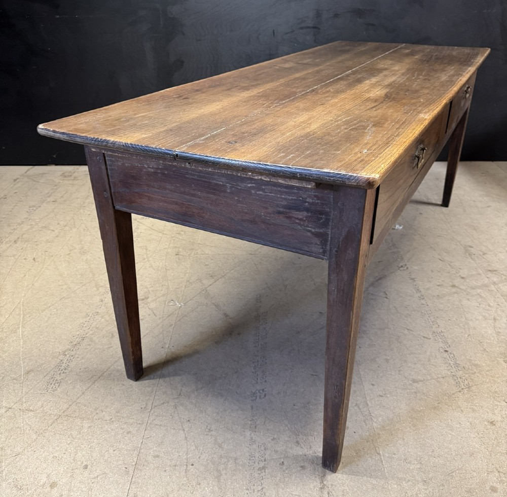 A rectangular antique French chestnut console prep table featuring two drawers with brass drop handles and square tapered legs. View XIV