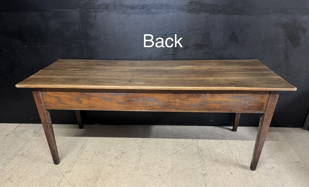 A rectangular antique French chestnut console prep table featuring two drawers with brass drop handles and square tapered legs. View XV