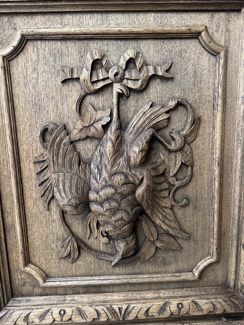 A dark oak French hunting sideboard featuring a carved stag head top pediment, open middle shelves, and lower cabinet doors decorated with carved game birds. View VII