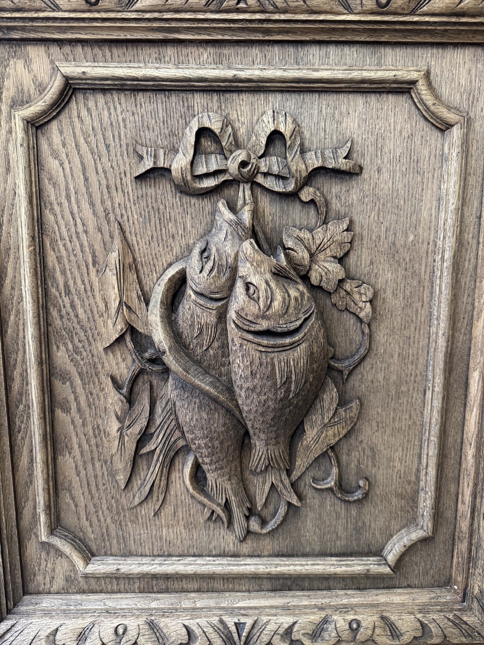 A dark oak French hunting sideboard featuring a carved stag head top pediment, open middle shelves, and lower cabinet doors decorated with carved game birds. View VIII