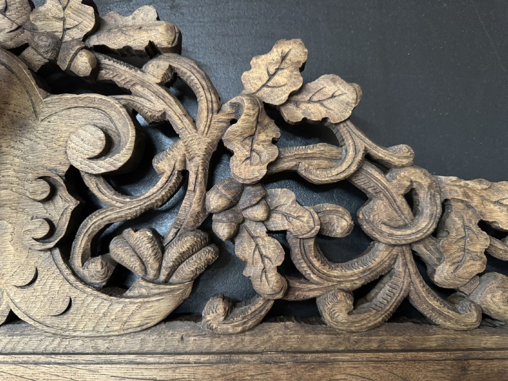A dark oak French hunting sideboard featuring a carved stag head top pediment, open middle shelves, and lower cabinet doors decorated with carved game birds. View XIV