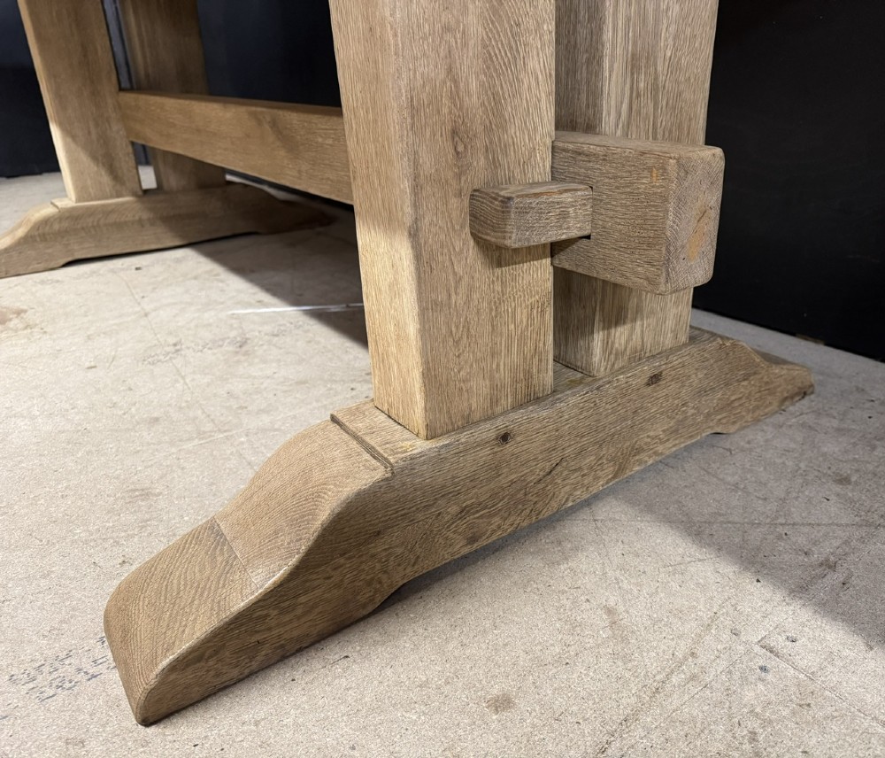 A solid bleached oak dining table featuring a thick rectangular top supported by a sturdy trestle base and central stretcher rail. View X
