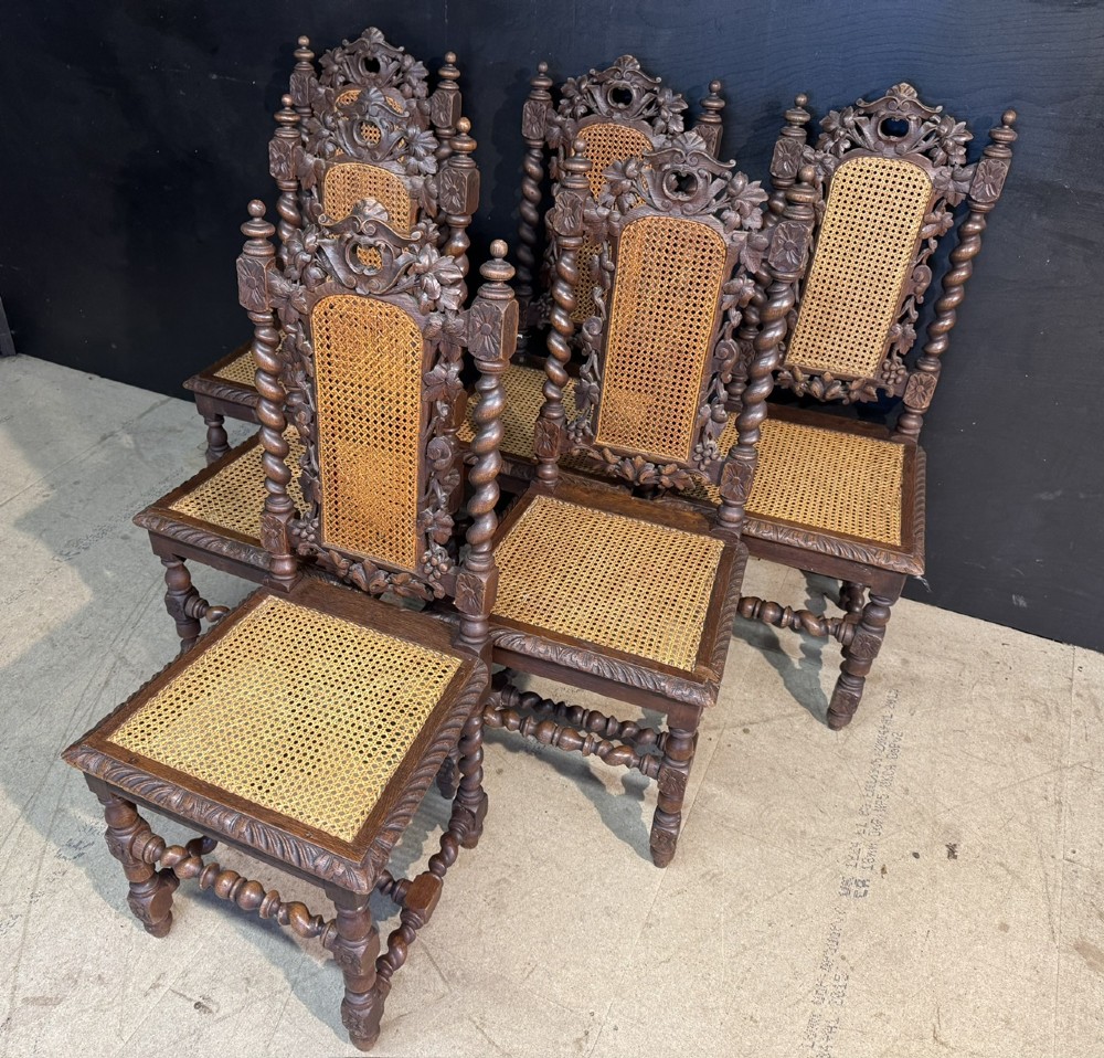 A set of six dark oak dining chairs with carved crestings, barley twist supports, and woven cane panels. View III