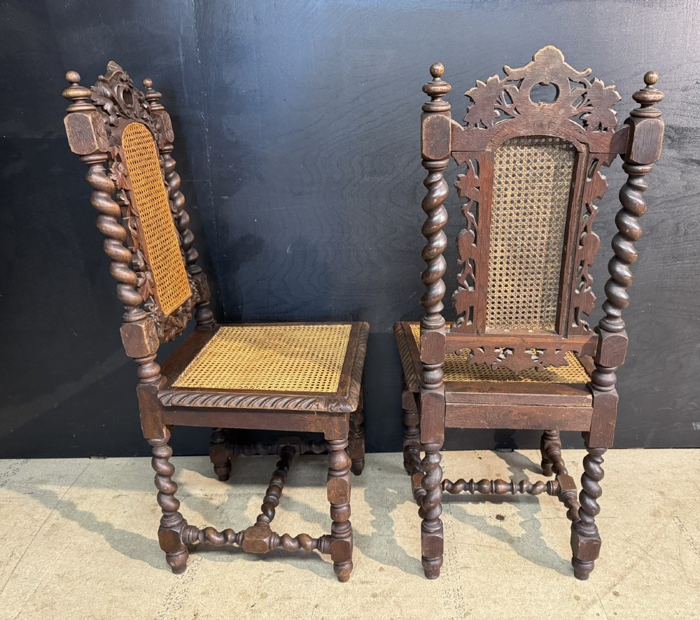 A set of six dark oak dining chairs with carved crestings, barley twist supports, and woven cane panels. View VII