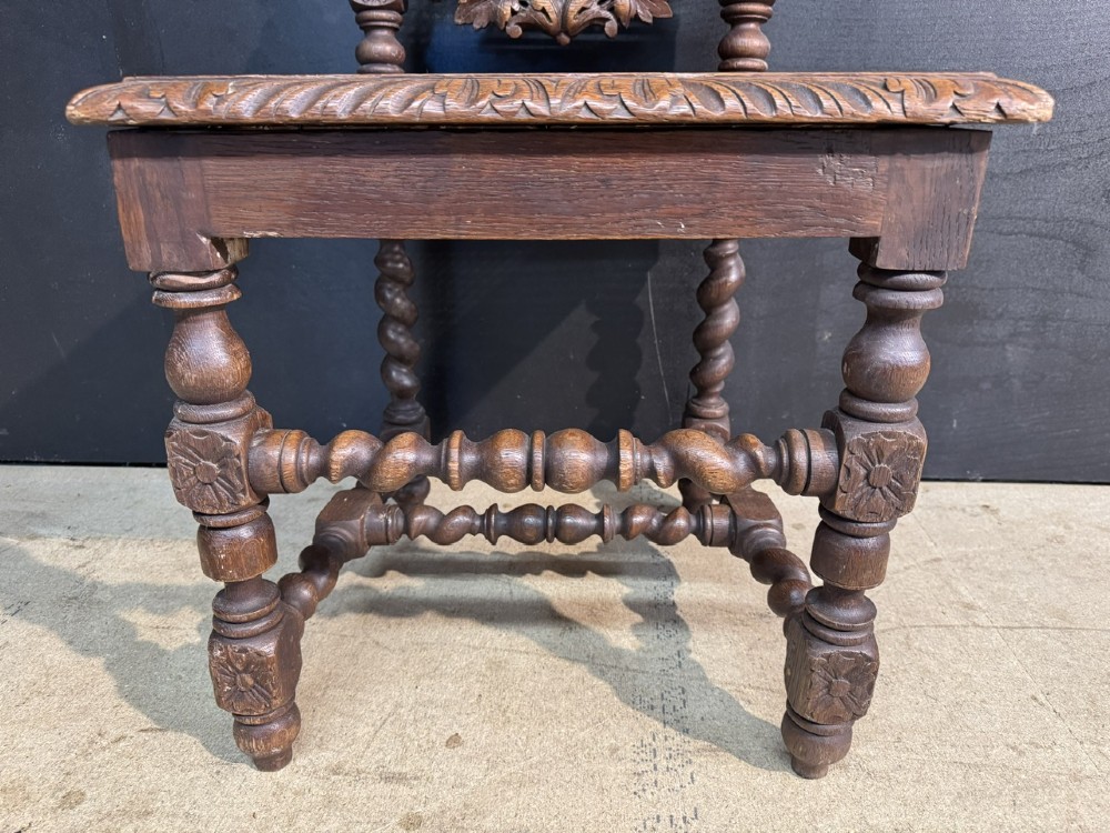 A set of six dark oak dining chairs with carved crestings, barley twist supports, and woven cane panels. View X