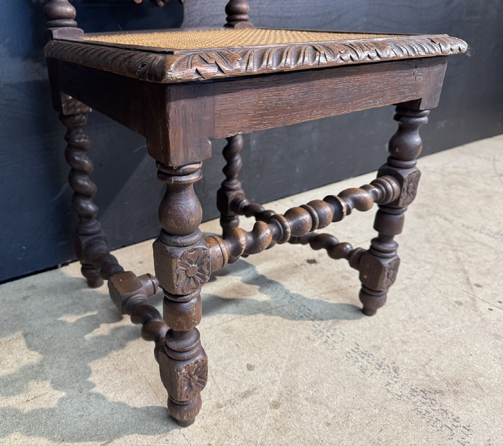 A set of six dark oak dining chairs with carved crestings, barley twist supports, and woven cane panels. View XII