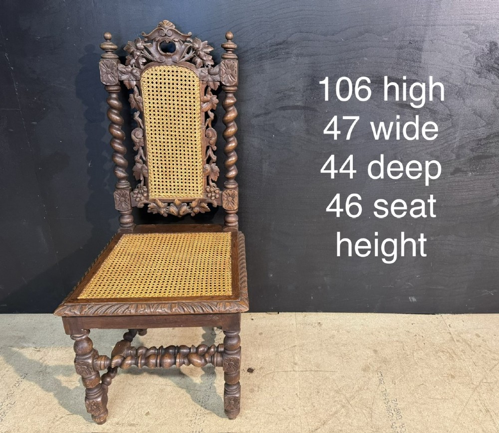 A set of six dark oak dining chairs with carved crestings, barley twist supports, and woven cane panels. View XIV