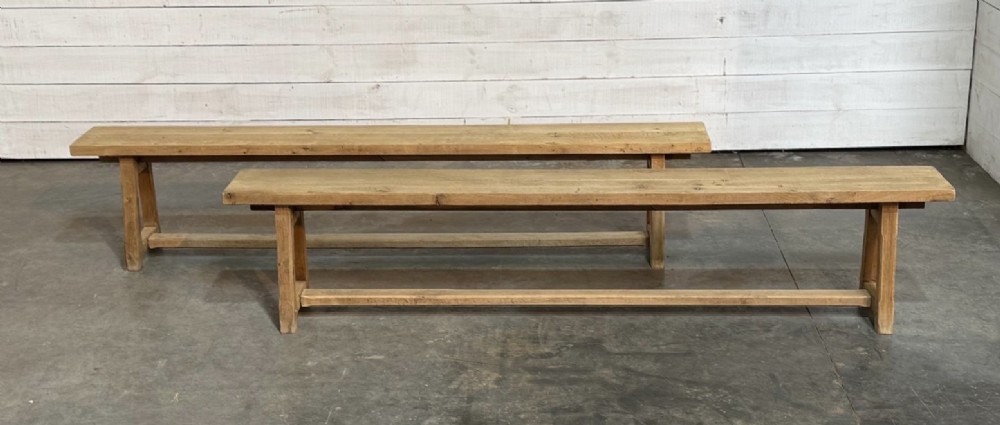 A pair of long rustic light oak dining benches with A-frame legs and cross-stretchers. View VI
