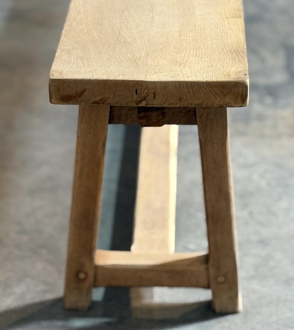 A pair of long rustic light oak dining benches with A-frame legs and cross-stretchers. View VIII