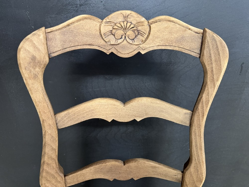A set of eight French farmhouse dining chairs featuring carved wooden ladderback frames, woven rush seats, and cabriole front legs. View VII