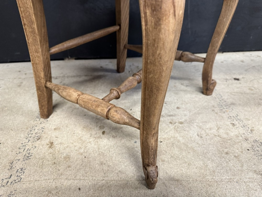A set of eight French farmhouse dining chairs featuring carved wooden ladderback frames, woven rush seats, and cabriole front legs. View IX