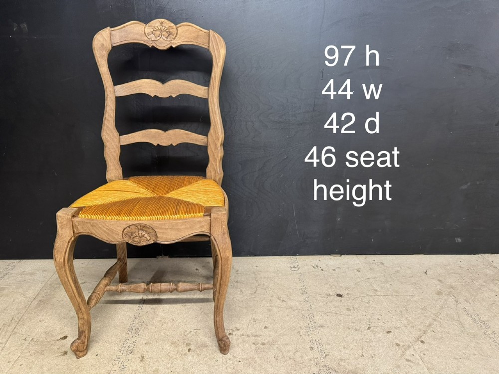 A set of eight French farmhouse dining chairs featuring carved wooden ladderback frames, woven rush seats, and cabriole front legs. View XII