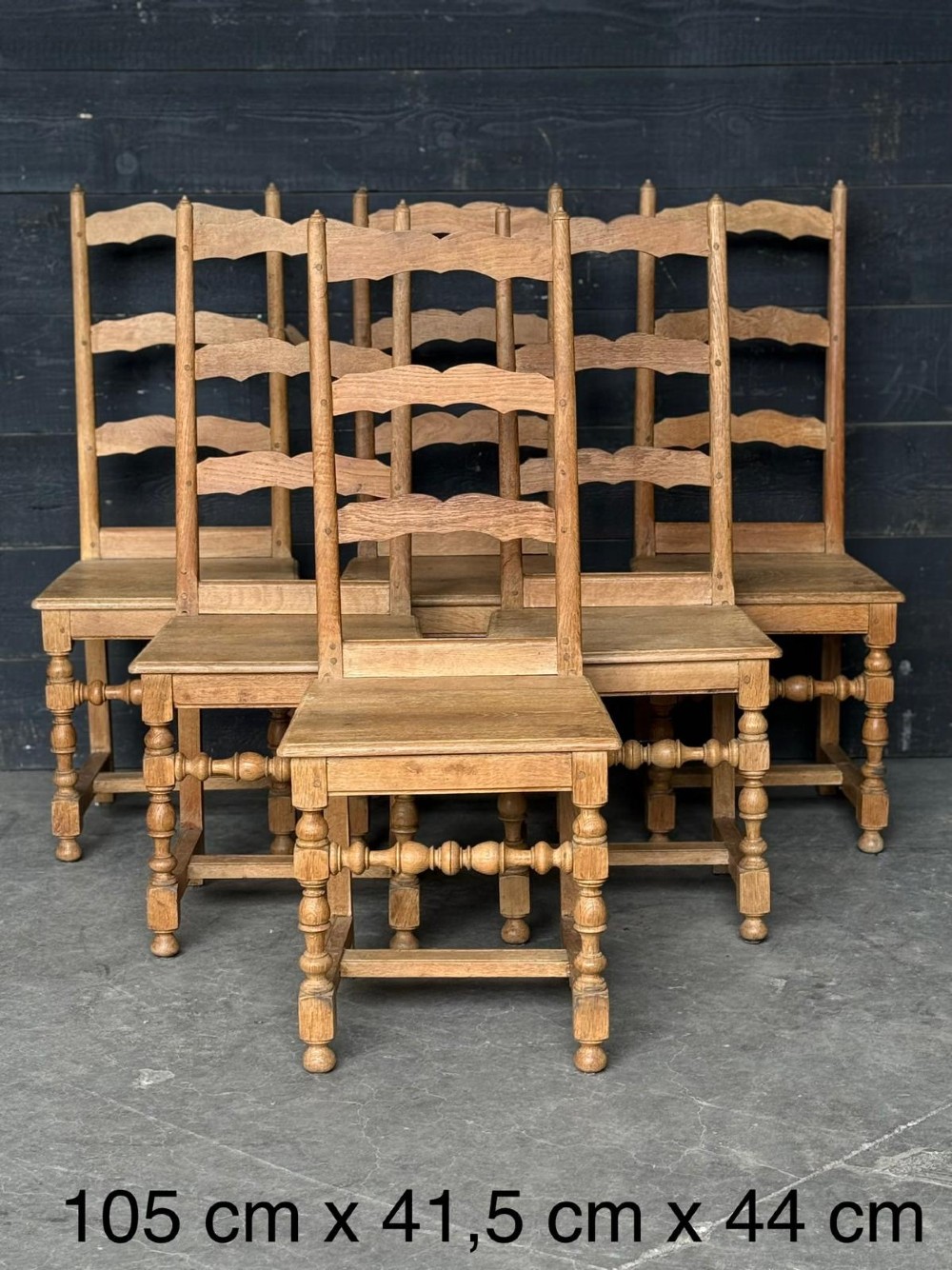 A set of six light oak ladderback dining chairs featuring wavy back slats, turned legs, and solid wooden seats. View II
