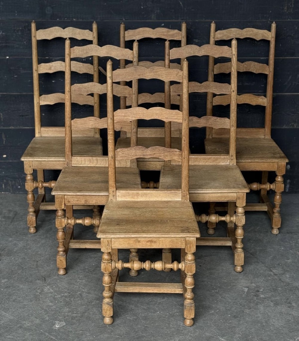 A set of six light oak ladderback dining chairs featuring wavy back slats, turned legs, and solid wooden seats. View IV