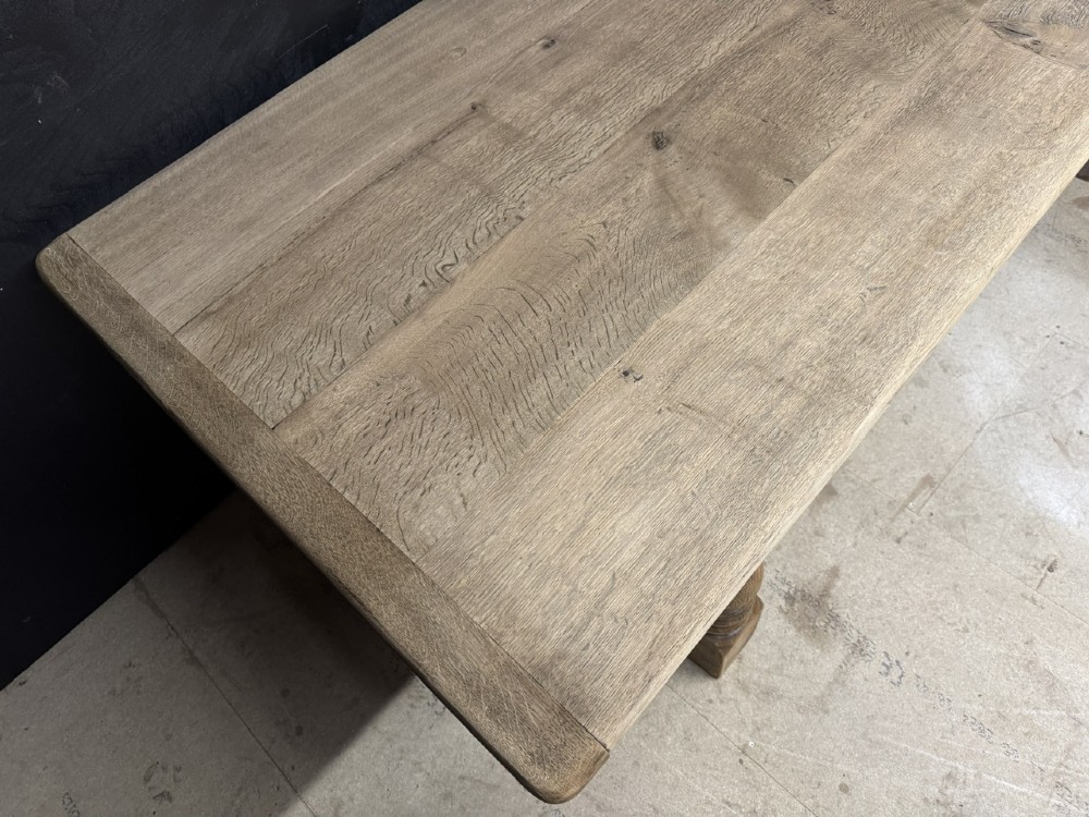 A large natural oak refectory dining table featuring turned legs, breadboard top ends, and an H-stretcher base. View VIII