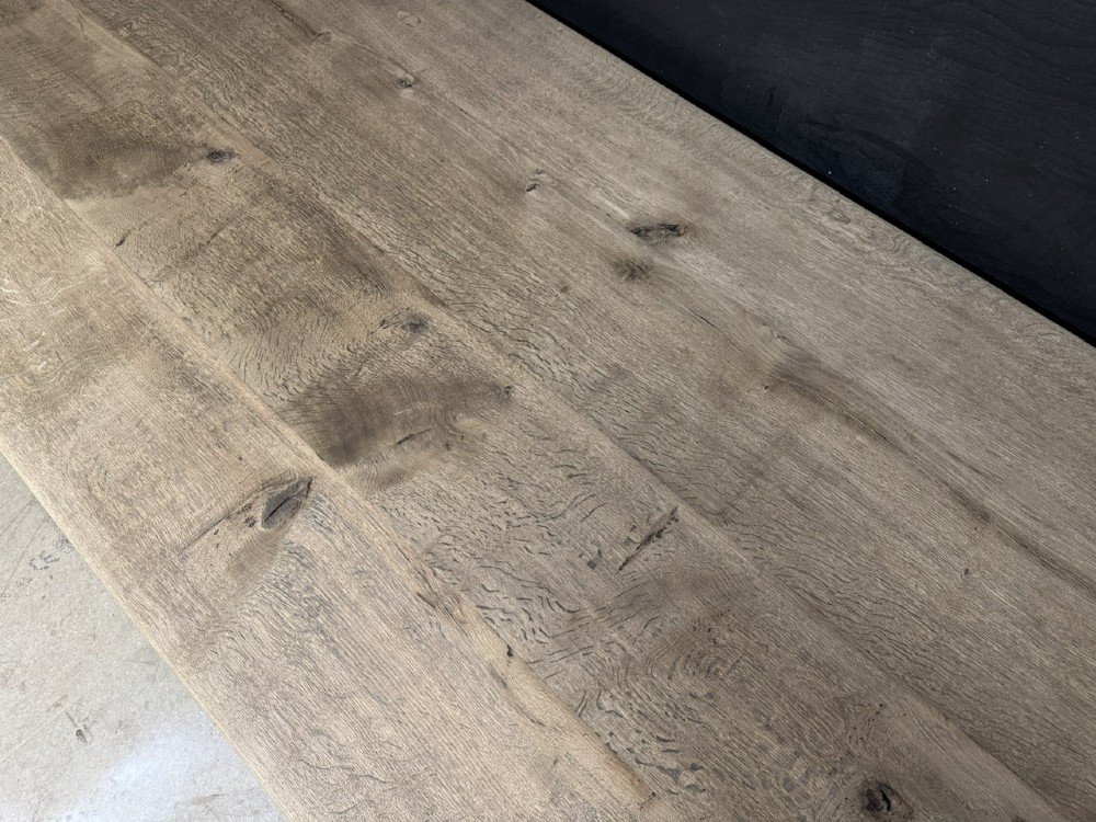 A large natural oak refectory dining table featuring turned legs, breadboard top ends, and an H-stretcher base. View IX