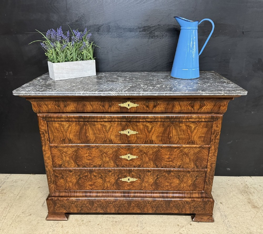 A 19th-century French Louis Philippe burr walnut commode featuring a grey marble top, four drawers, and ornate brass keyhole escutcheons. View II