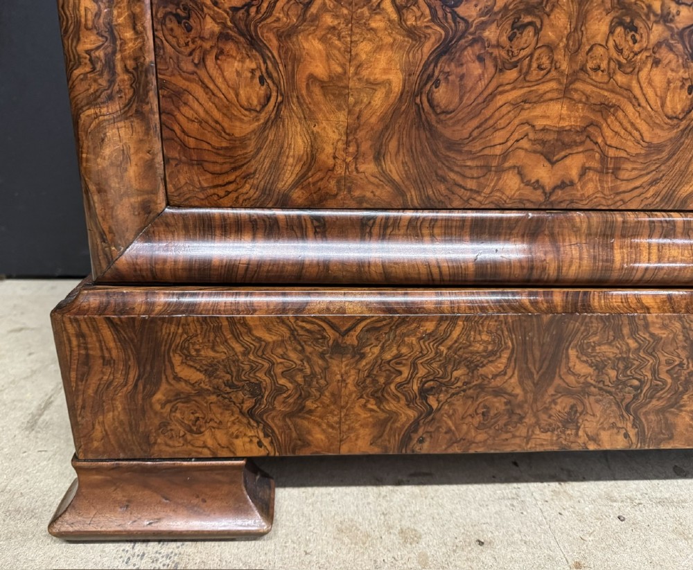 A 19th-century French Louis Philippe burr walnut commode featuring a grey marble top, four drawers, and ornate brass keyhole escutcheons. View VI