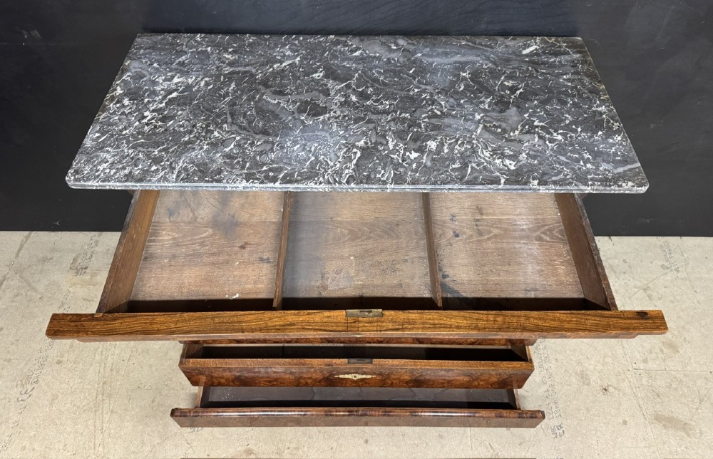 A 19th-century French Louis Philippe burr walnut commode featuring a grey marble top, four drawers, and ornate brass keyhole escutcheons. View XIII