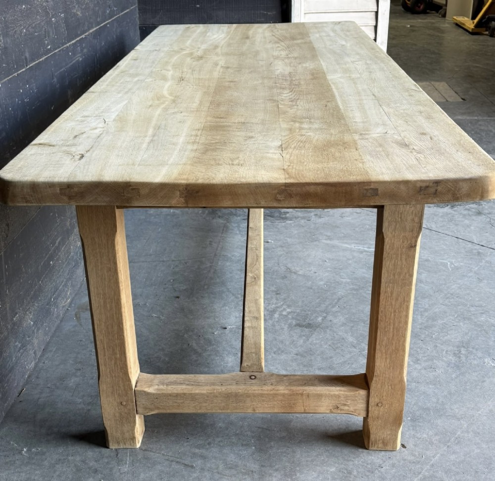 A large rectangular natural oak farmhouse dining table featuring a thick plank top, square legs, and an H-stretcher base. View IV