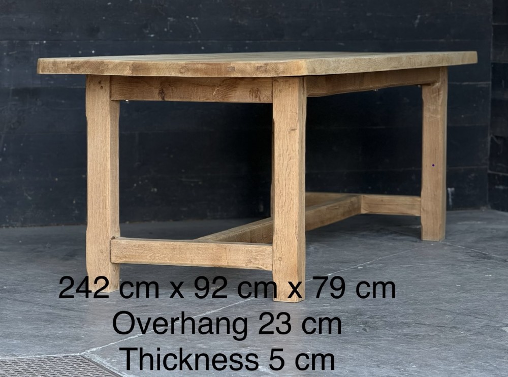A large rectangular natural oak farmhouse dining table featuring a thick plank top, square legs, and an H-stretcher base. View IX