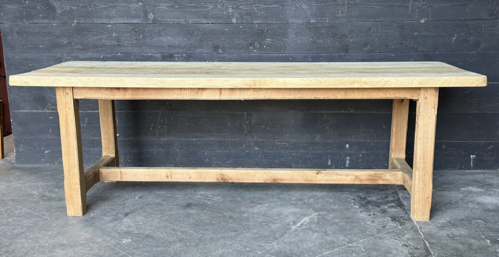 A large rectangular natural oak farmhouse dining table featuring a thick plank top, square legs, and an H-stretcher base. View XIV