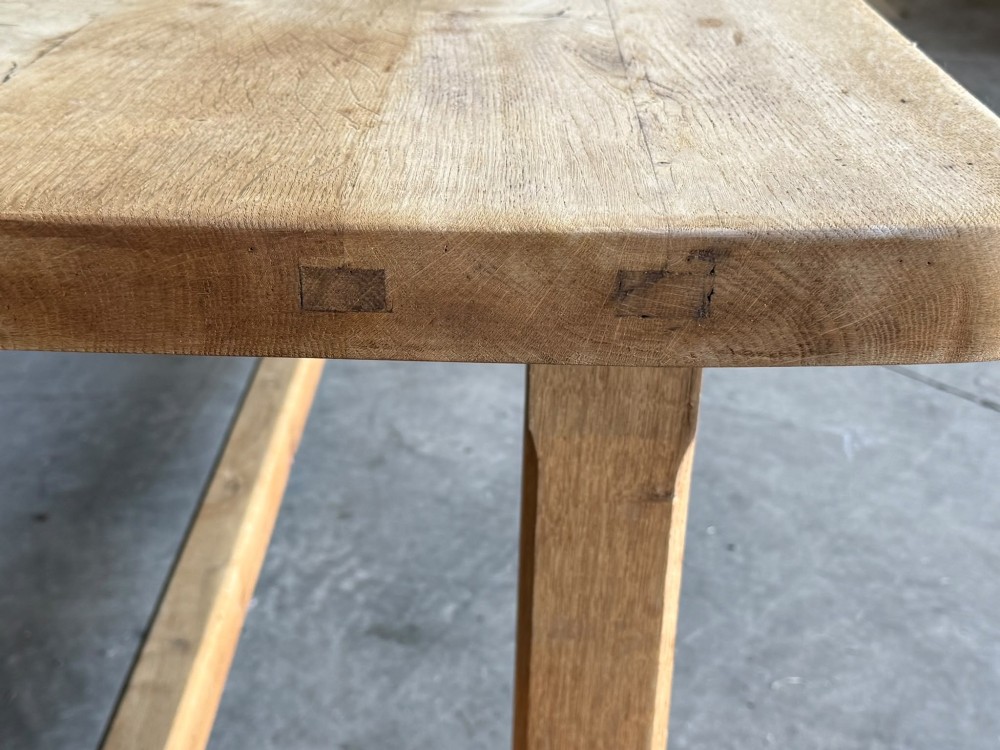 A large rectangular natural oak farmhouse dining table featuring a thick plank top, square legs, and an H-stretcher base. View XV