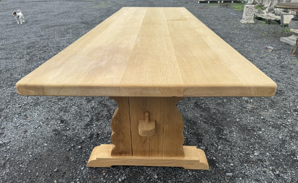 A three-metre-long natural oak trestle dining table featuring a solid plank top and a pegged central stretcher base. View III