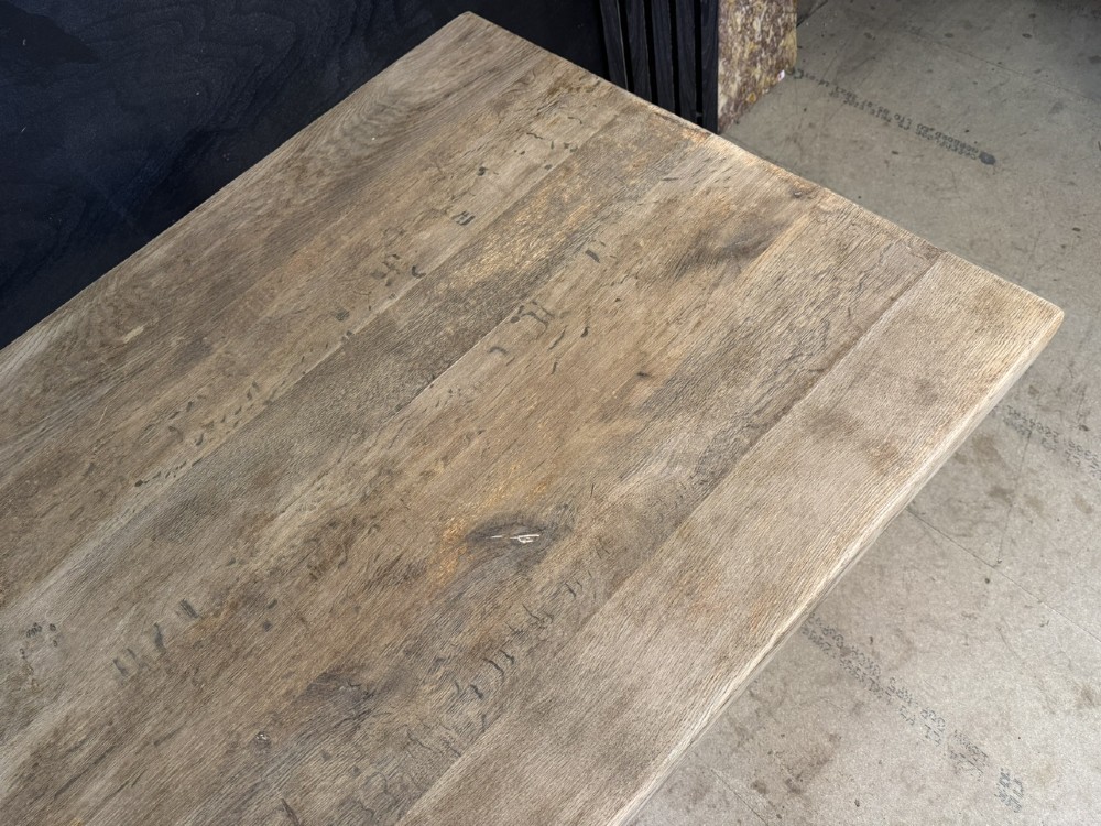 An extra long natural oak refectory dining table featuring a timber plank top supported by twin turned baluster trestle legs connected by a floor-level stretcher. View VI