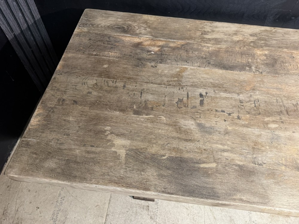 An extra long natural oak refectory dining table featuring a timber plank top supported by twin turned baluster trestle legs connected by a floor-level stretcher. View VII