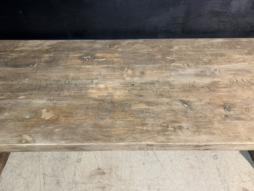 An extra long natural oak refectory dining table featuring a timber plank top supported by twin turned baluster trestle legs connected by a floor-level stretcher. View VIII